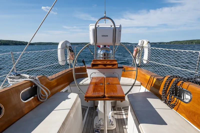 Slide: The Image of Cockpit of 1995 Hinckley Sou'wester 42 MKII sailboat on open water, featuring wooden accents. - 38