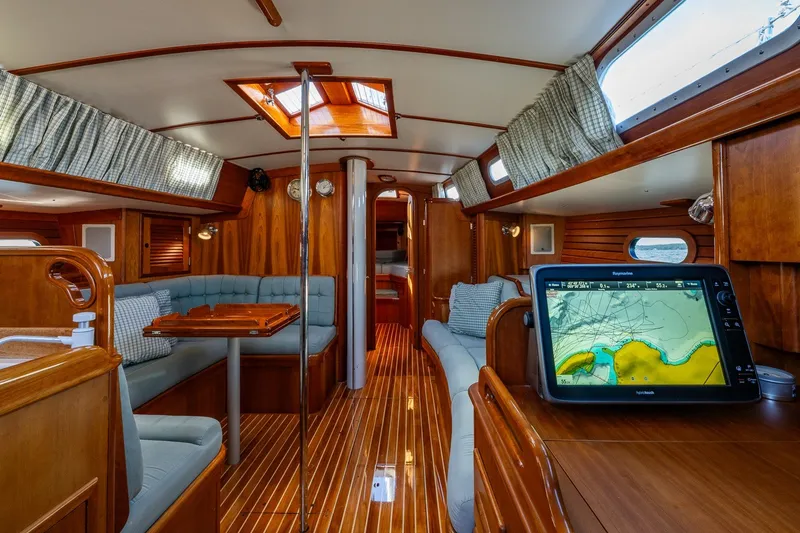 Slide: The Image of Luxurious interior of 1995 Hinckley Sou'wester 42 MKII sailboat with wood finish and navigation system. - 21