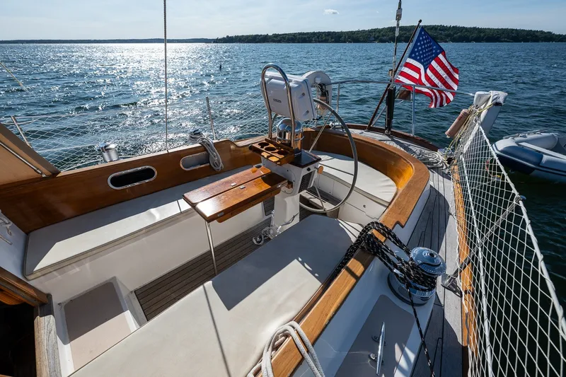 Slide: The Image of Hinckley Sou'wester 42 MKII sailboat cockpit with American flag, 1995 model, on sunny waters. - 56