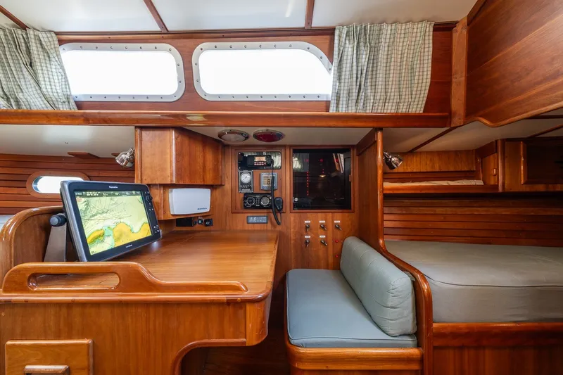 Slide: The Image of Interior of 1995 Hinckley Sou'wester 42 MKII sailboat with navigation station and cozy seating. - 18