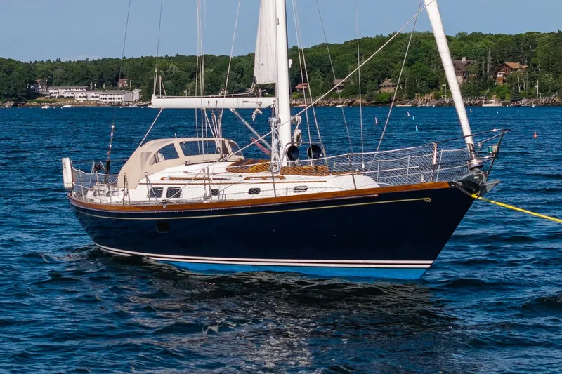 Slide: The Image of Hinckley Sou'wester 42 MKII sailboat from 1995 on a serene lake. - 7