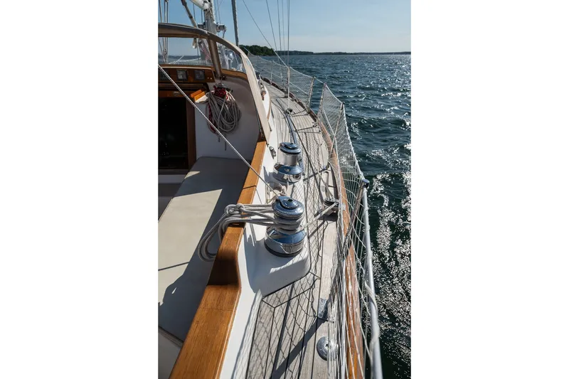 Slide: The Image of Hinckley Sou'wester 42 MKII sailboat deck, 1995 model, with ropes and winches, sailing on open water. - 43