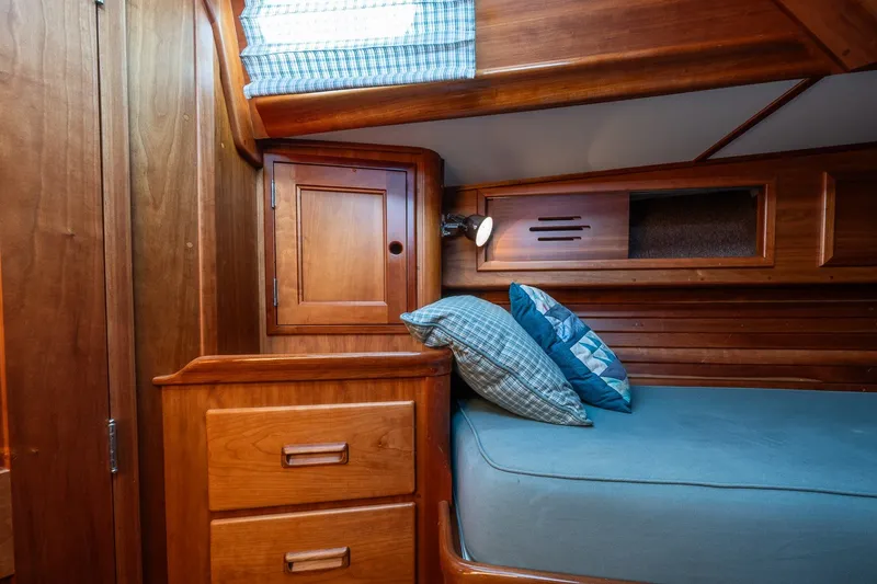 Slide: The Image of Cozy cabin interior of 1995 Hinckley Sou'wester 42 MKII with wooden cabinetry and blue bedding. - 33