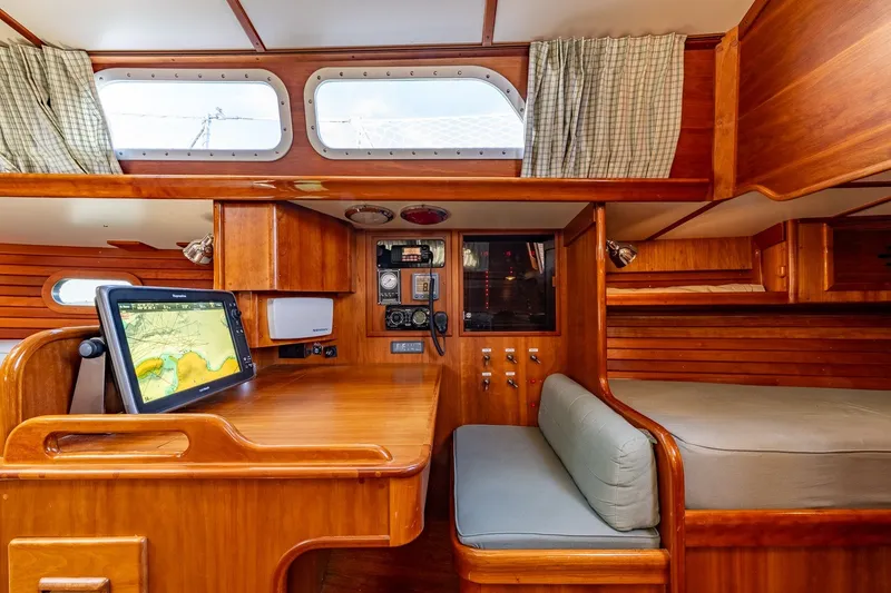 Slide: The Image of Interior of 1995 Hinckley Sou'wester 42 MKII sailboat with navigation station and cozy seating. - 19