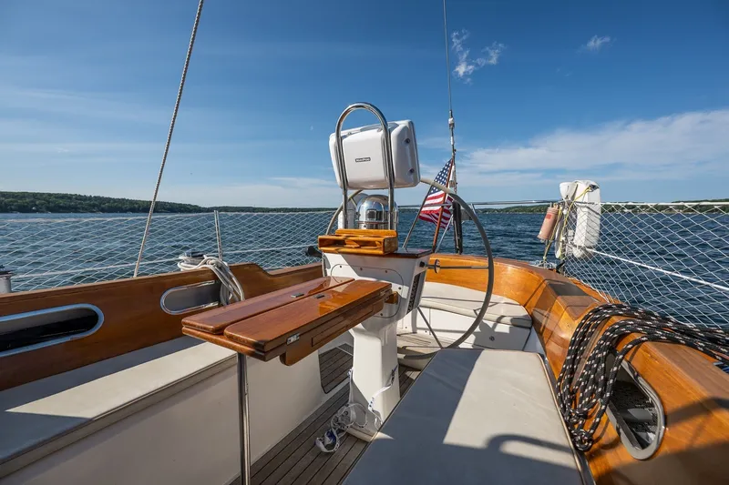 Slide: The Image of Hinckley Sou'wester 42 MKII sailboat cockpit with wooden accents, sailing on a sunny day. - 61