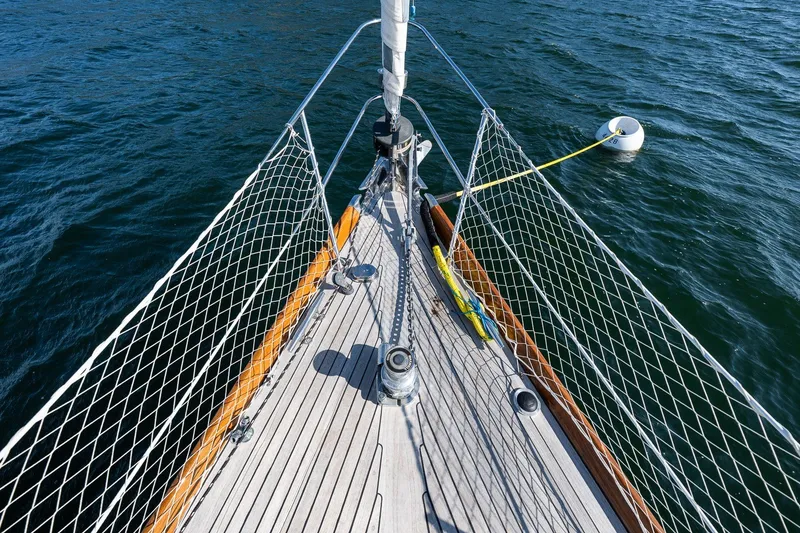 Slide: The Image of Bow of 1995 Hinckley Sou'wester 42 MKII sailboat on water with mooring buoy. - 50
