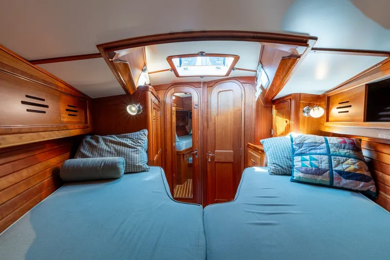 Slide: The Image of Interior cabin of 1995 Hinckley Sou'wester 42 MKII yacht with wooden finish and cozy bedding. - 35