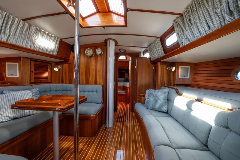 Slide: The Image of Luxurious interior of 1995 Hinckley Sou'wester 42 MKII sailboat with wood finish and plush seating. - 16