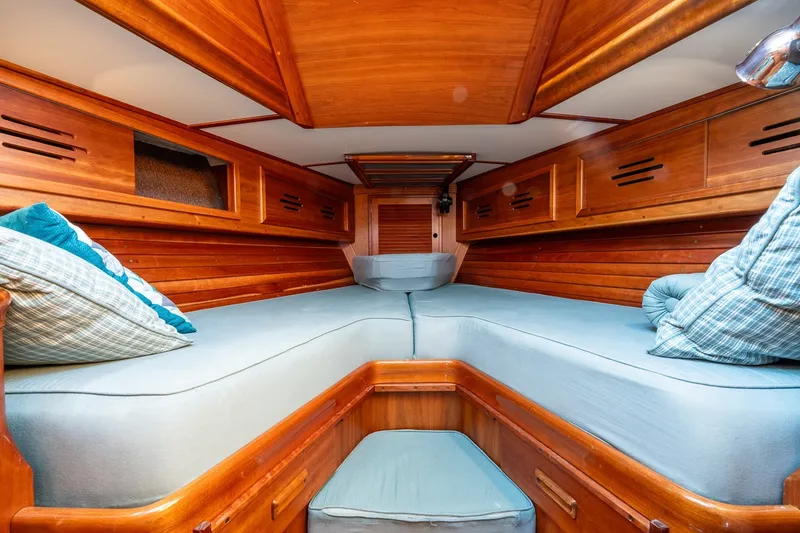 Slide: The Image of Cozy cabin interior of 1995 Hinckley Sou'wester 42 MKII with wooden finish and blue cushions. - 31