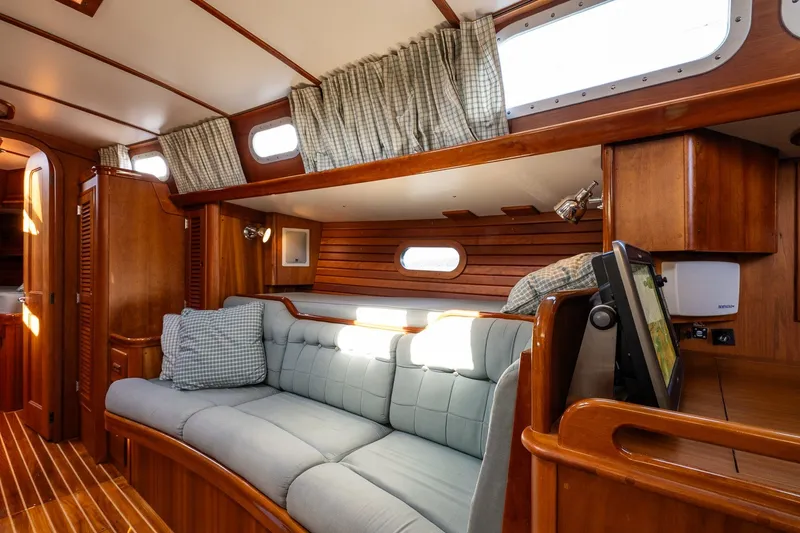 Slide: The Image of Interior of 1995 Hinckley Sou'wester 42 MKII yacht with wooden finish and cozy seating. - 24
