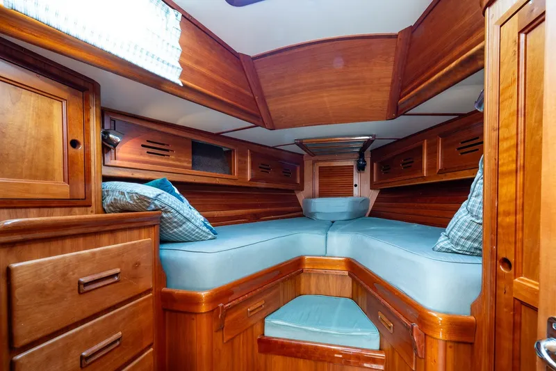 Slide: The Image of Cozy cabin interior of 1995 Hinckley Sou'wester 42 MKII with wooden finish and blue cushions. - 30