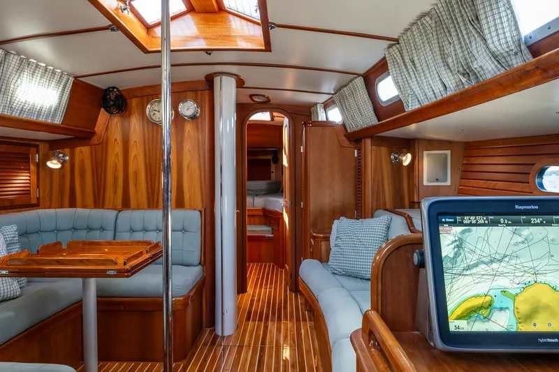Slide: The Image of Luxurious interior of 1995 Hinckley Sou'wester 42 MKII sailboat with wood finish and navigation system. - 22