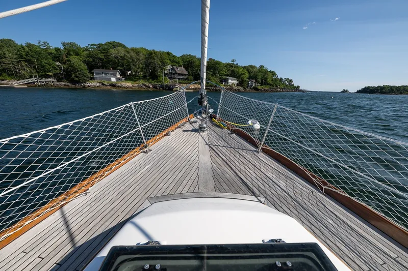 Slide: The Image of Sailing on a 1995 Hinckley Sou'wester 42 MKII, approaching a scenic coastal landscape. - 49