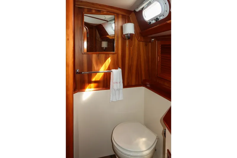 Slide: The Image of Hinckley Sou'wester 42 MKII 1995 yacht bathroom with wooden interior and porthole window. - 64