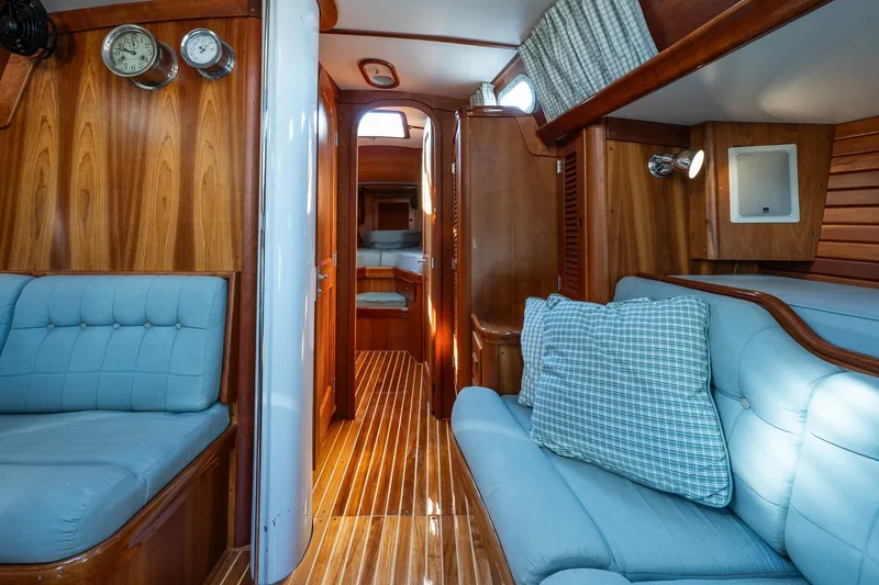 Slide: The Image of Interior of 1995 Hinckley Sou'wester 42 MKII yacht with wooden finish and blue seating. - 25