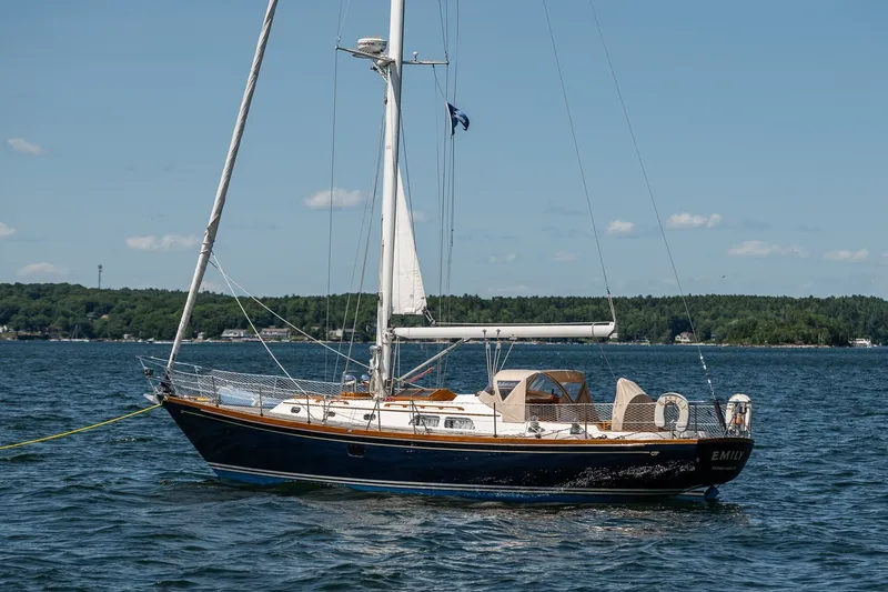 Slide: The Image of Hinckley Sou'wester 42 MKII sailboat from 1995 on calm waters, clear sky background. - 11