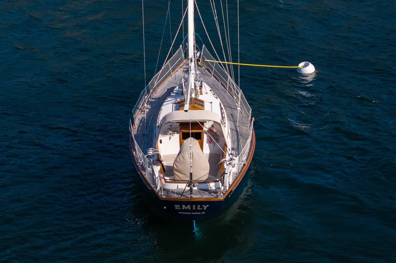 Slide: The Image of Hinckley Sou'wester 42 MKII sailboat from 1995 moored on calm blue water. - 2