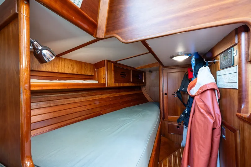 Slide: The Image of Hinckley Sou'wester 42 MKII 1995 cabin interior with wooden finish and cozy sleeping area. - 17