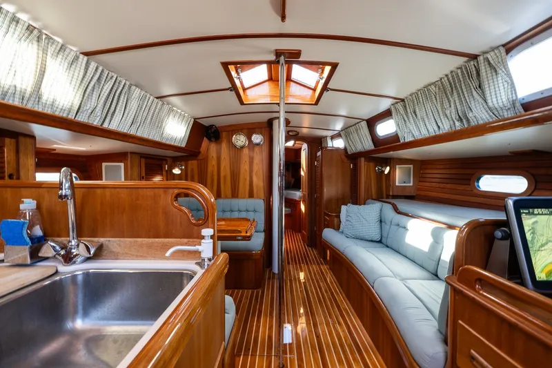 Slide: The Image of Interior of 1995 Hinckley Sou'wester 42 MKII yacht with wood finish and cozy seating. - 12