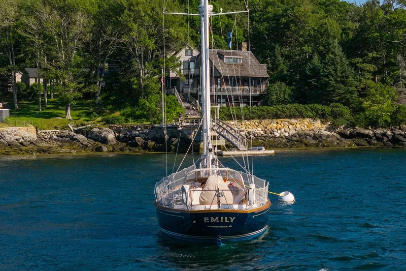 Slide: The Image of Hinckley Sou'wester 42 MKII sailboat anchored near a scenic shoreline, 1995 model. - 1