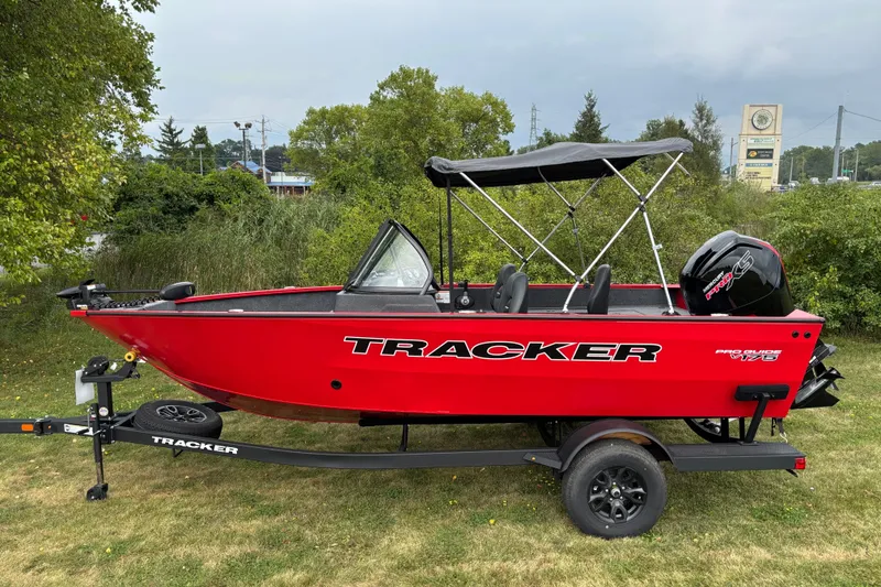 The Image of 2026 Tracker Pro Guide V-175 WT boat in vibrant red on a trailer, parked outdoors. - 0
