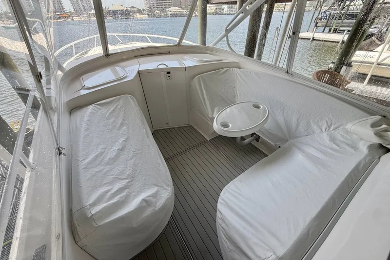Slide: The Image of 2020 Intrepid 407 Cuddy boat interior with covered seating and small table. - 17