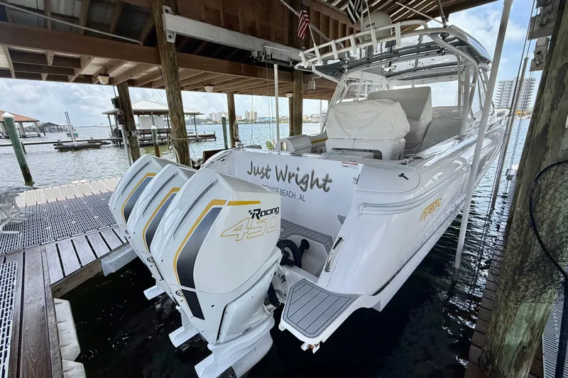 Slide: The Image of 2020 Intrepid 407 Cuddy boat docked with triple 450 Racing engines. - 11