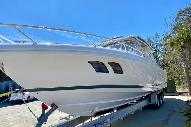 Slide: The Image of 2020 Intrepid 407 Cuddy boat on trailer under clear blue sky. - 10