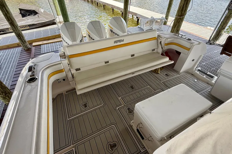 Slide: The Image of 2020 Intrepid 407 Cuddy boat interior with seating and outboard motors. - 19