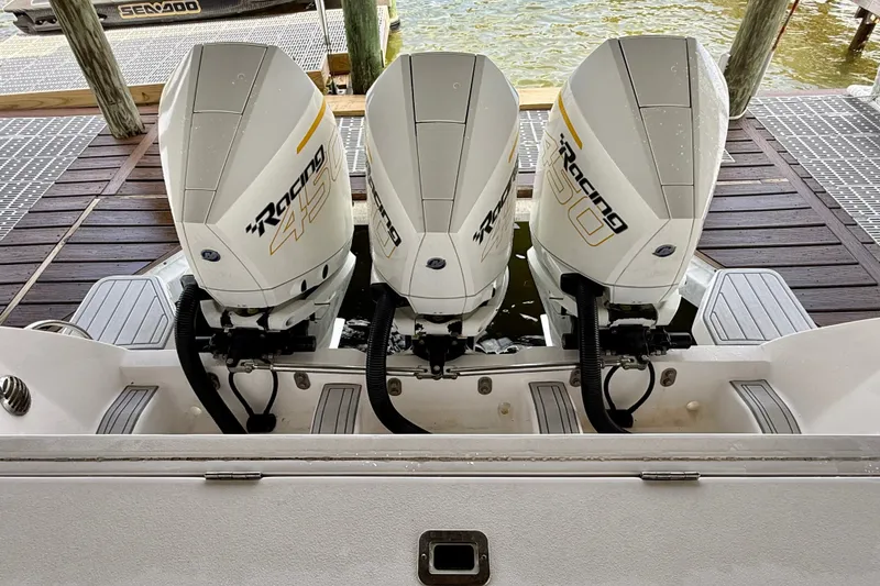 Slide: The Image of Triple outboard engines on a 2020 Intrepid 407 Cuddy boat at a dock. - 15