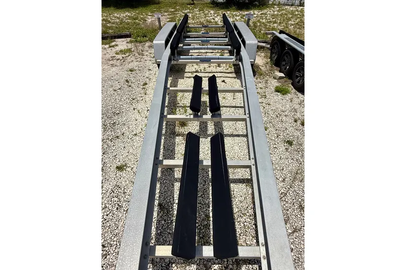 Slide: The Image of Trailer for 2020 Intrepid 407 Cuddy boat on gravel surface. - 24