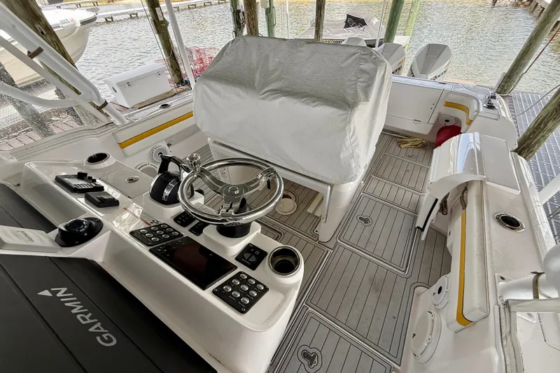 Slide: The Image of 2020 Intrepid 407 Cuddy boat cockpit with Garmin navigation and covered helm station. - 18
