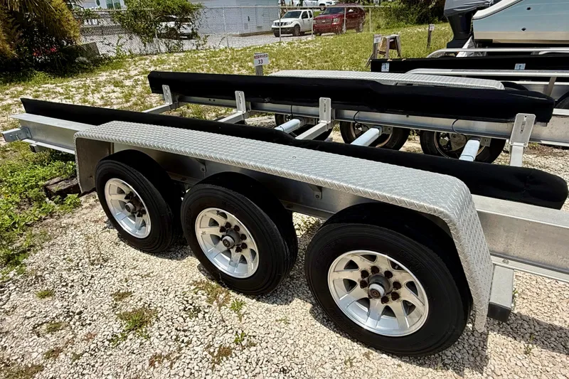 Slide: The Image of Triple-axle boat trailer for 2020 Intrepid 407 Cuddy, parked on gravel. - 25