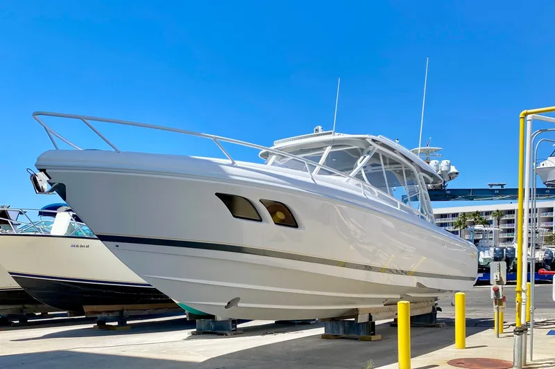 Slide: The Image of 2020 Intrepid 407 Cuddy boat on display under clear blue sky. - 2