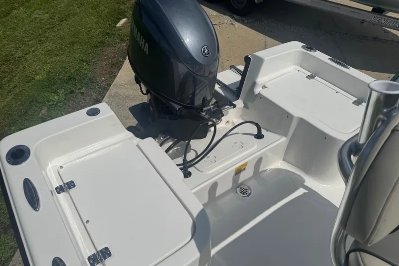 Slide: The Image of 2027 Key West 1720 Center Console boat with Yamaha outboard motor, docked on grass. - 10