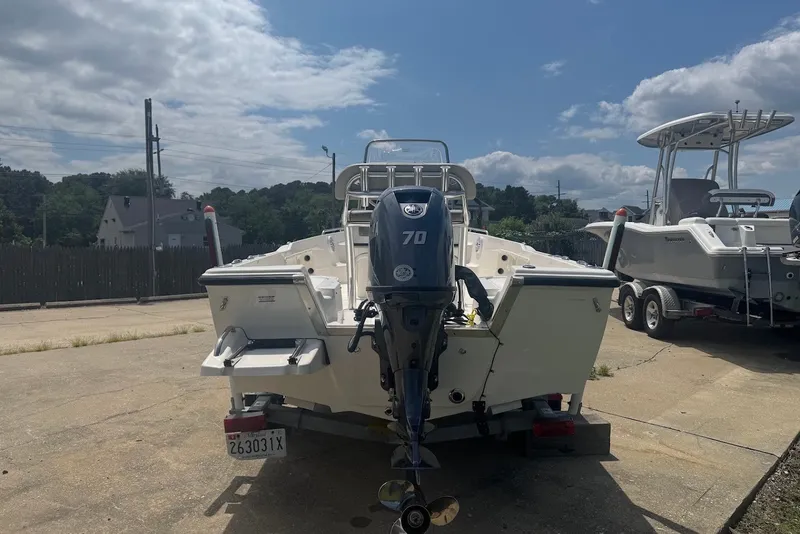 Slide: The Image of 2027 Key West 1720 Center Console boat with outboard motor in a sunny outdoor setting. - 4
