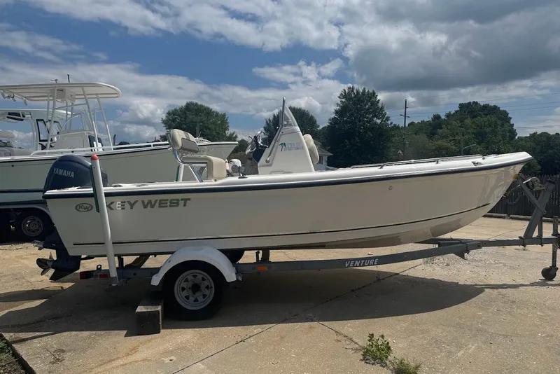 Slide: The Image of 2027 Key West 1720 Center Console boat on trailer, parked outdoors under cloudy sky. - 6