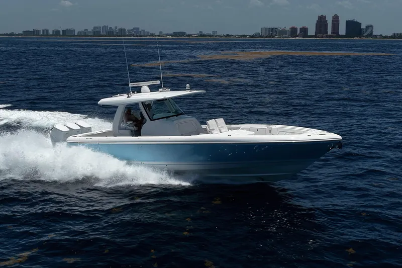 Slide: The Image of 2023 Intrepid 427 Nomad FE cruising on open water, city skyline in background. - 3