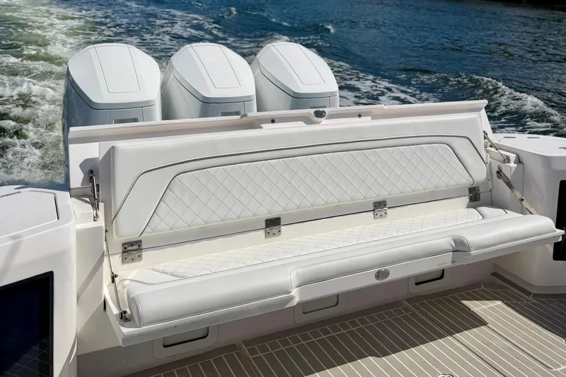 Slide: The Image of 2023 Intrepid 427 Nomad FE boat with luxurious white seating and powerful engines. - 30