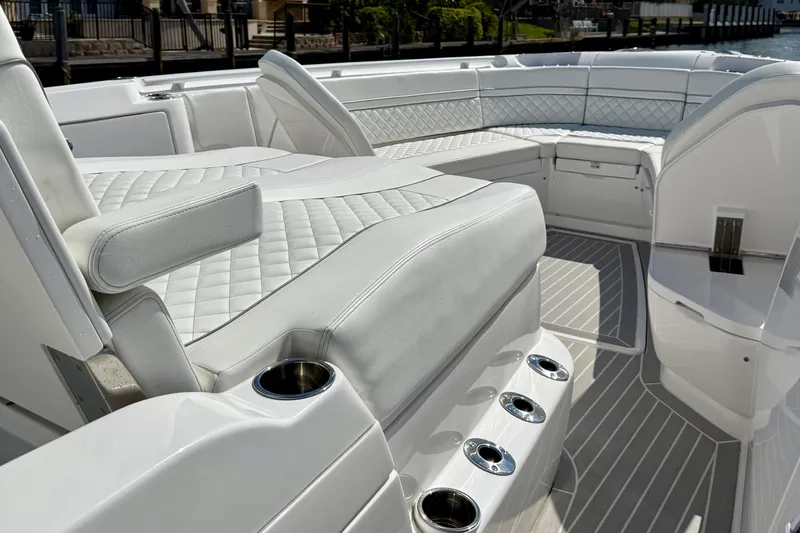 Slide: The Image of Luxurious seating on 2023 Intrepid 427 Nomad FE boat, featuring quilted upholstery and cup holders. - 18