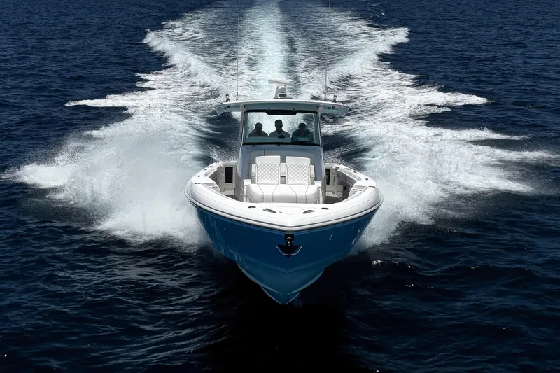 Slide: The Image of 2023 Intrepid 427 Nomad FE cruising on open water, leaving a dynamic wake. - 4
