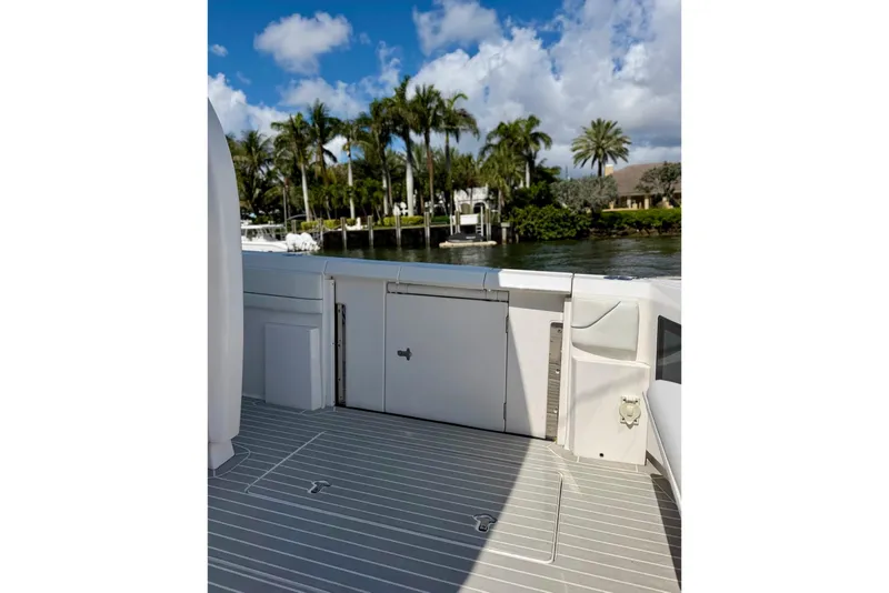 Slide: The Image of 2023 Intrepid 427 Nomad FE boat deck with scenic waterfront view. - 35