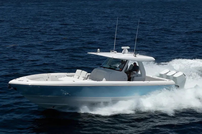 Slide: The Image of 2023 Intrepid 427 Nomad FE cruising on open water, showcasing sleek design and powerful engines. - 1