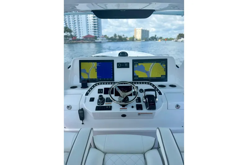 Slide: The Image of Cockpit of 2023 Intrepid 427 Nomad FE boat with dual navigation screens and controls. - 12