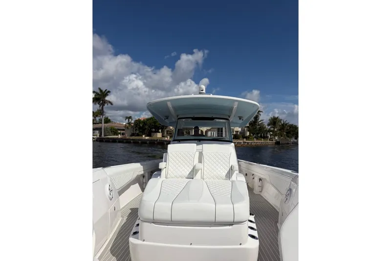 Slide: The Image of 2023 Intrepid 427 Nomad FE boat on water, featuring luxurious seating and sleek design. - 16