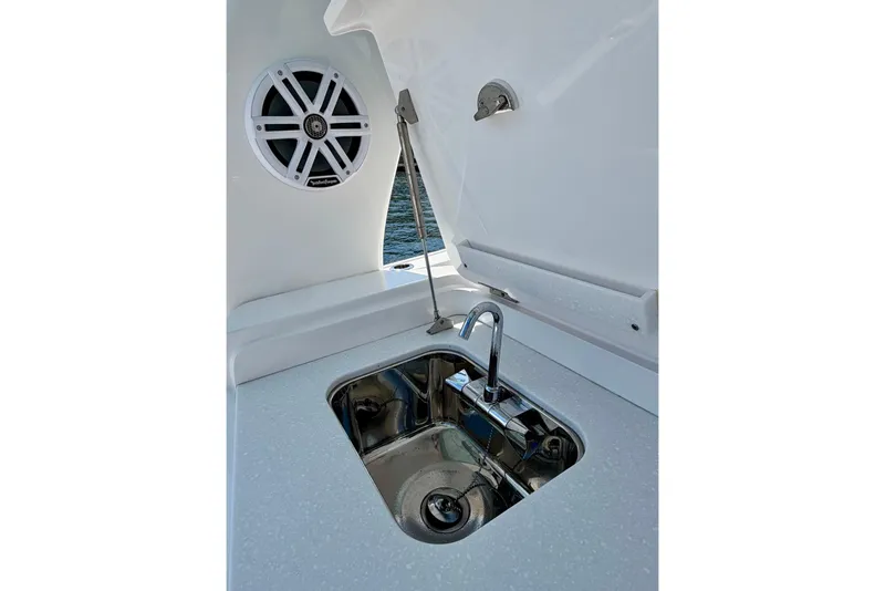 Slide: The Image of Luxury sink and speaker on 2023 Intrepid 427 Nomad FE boat deck. - 32