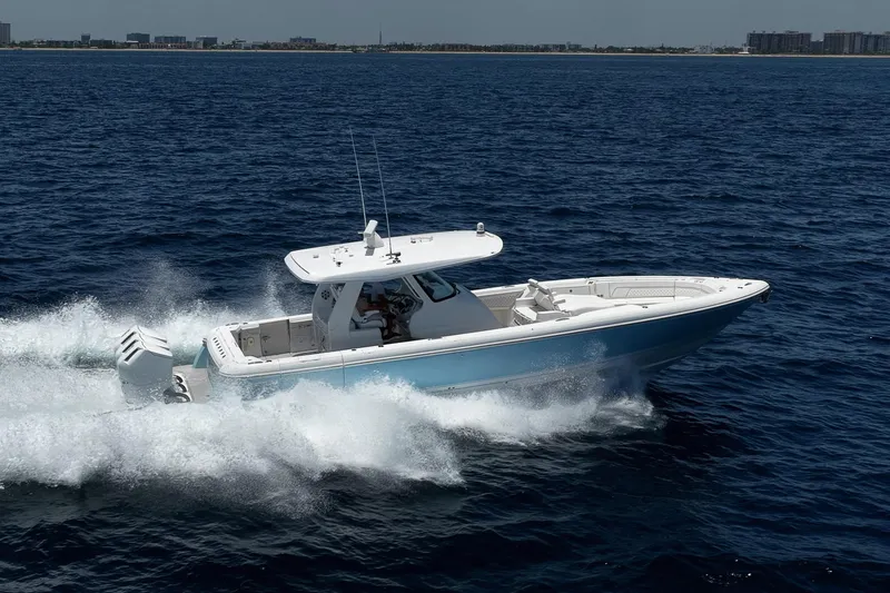 Slide: The Image of 2023 Intrepid 427 Nomad FE cruising on open water, showcasing sleek design and powerful engines. - 5