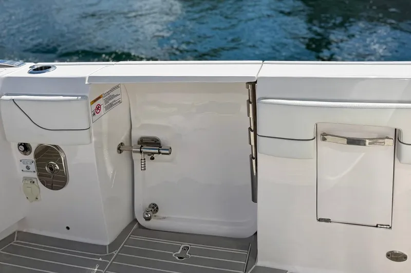 Slide: The Image of 2023 Intrepid 427 Nomad FE boat deck with sleek design and water backdrop. - 34