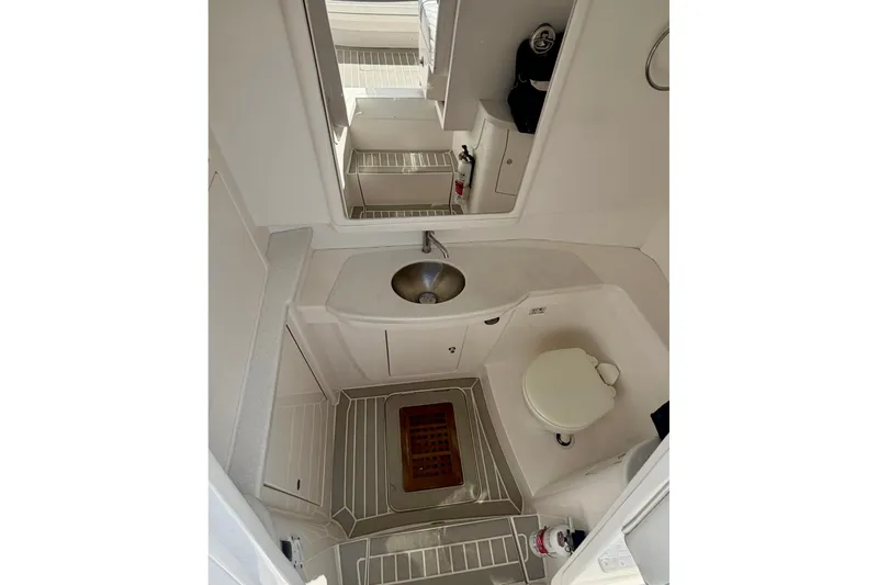 Slide: The Image of 2023 Intrepid 427 Nomad FE boat bathroom with sink, toilet, and mirror. - 28