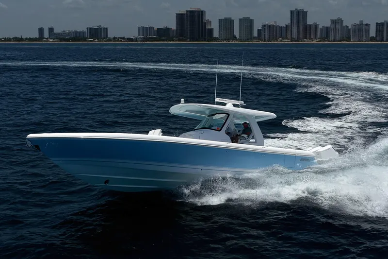 Slide: The Image of 2023 Intrepid 427 Nomad FE cruising on ocean near city skyline. - 6